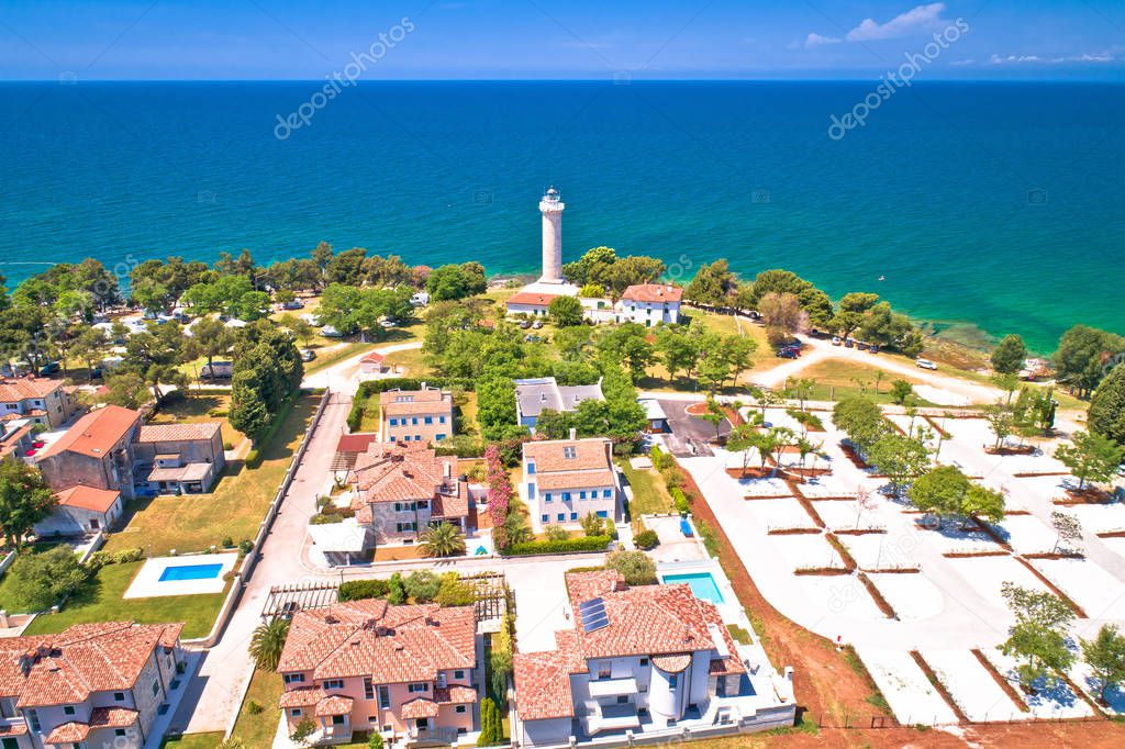 Savudrija lighthouse and turquoise crystal clear rocky beach aer