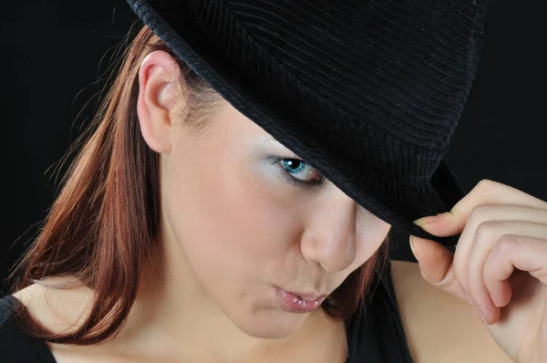 Pleasing girl hold on the hat Royalty Free Stock Images