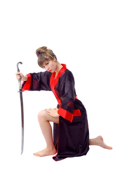 Beautiful girl in japan clothes on knee with katana sword — Stock Photo, Image