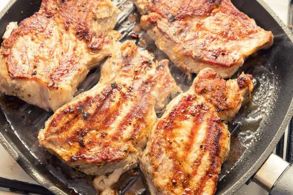 Bife de porco fresco cozinhando na grelha da panela . — Fotografia de Stock