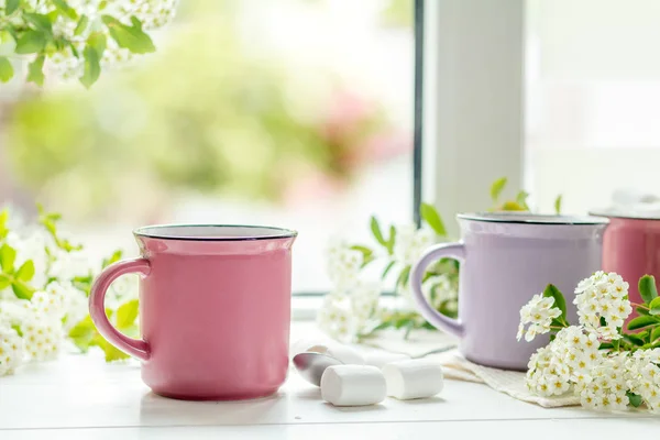 Hot cocoa with marshmallows in pink cups