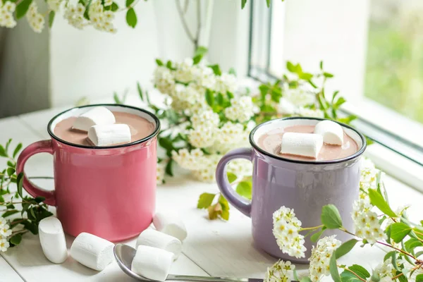 Hot cocoa with marshmallows in pink cups