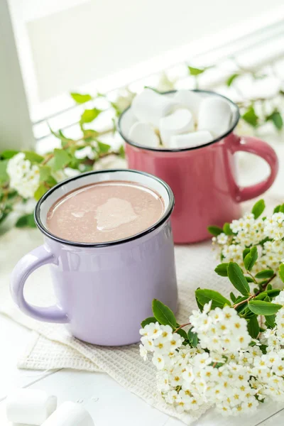Hot cocoa with marshmallows in pink cups