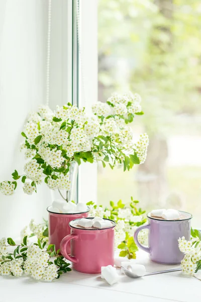 Hot cocoa with marshmallows in pink cups