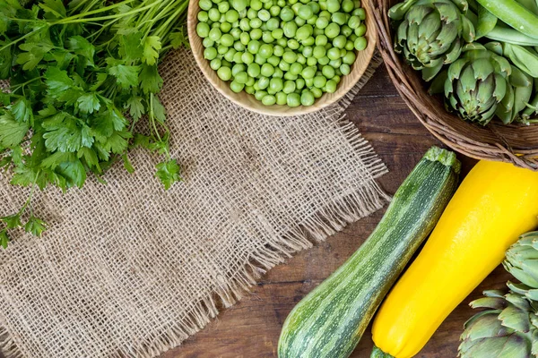 Fresh organic green vegetables on wooden floor