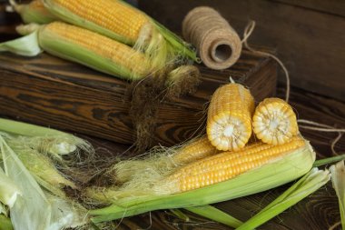 Taze tatlı mısır koçanı rustik ahşap masada üzerinde yakın çekim. Tonda