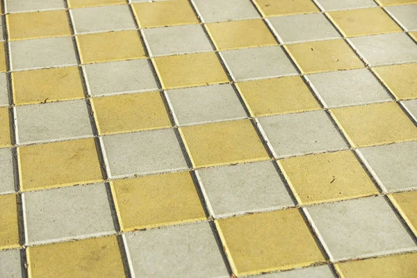 Pavement. Sidewalk tile background. Pavement tile. Top view. Closeup. Footpath. Bright tone two colors. — Stock Photo, Image