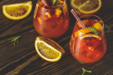 Kırmızı acı, kuru beyaz şarap, soda, kırmızı turuncu ve buzlu Milano spritzer alkollü kokteyli. Koyu tahta arkaplan, seçici odak