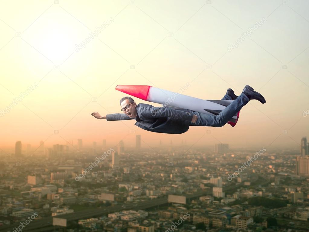 business man flying with rocket over skyscraper scene