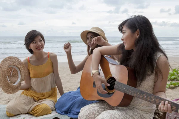 Younger asian woman friend vacation relaxing playing guitar and — Stock Photo, Image