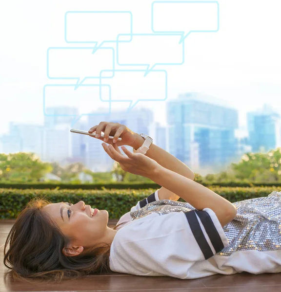 City life style of asian woman lying and touching on mobile phon — Stock Photo, Image