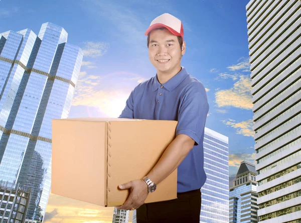 delivery man toothy smiling face and holding card box delivering