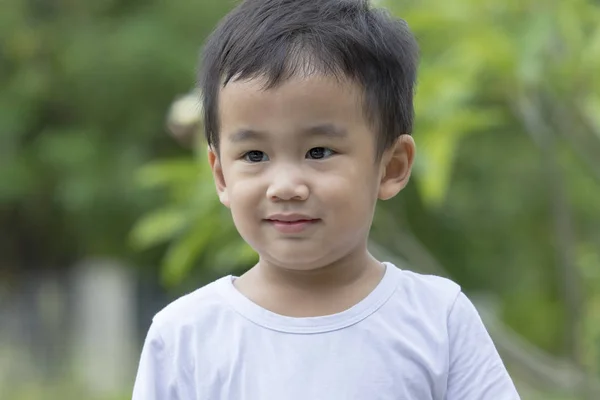 Portrait head shot of asian children smiling face against green — Stock Photo, Image