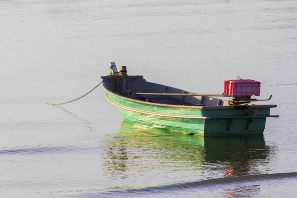 Lonely metal boat floating on sea beach — Stock Photo, Image