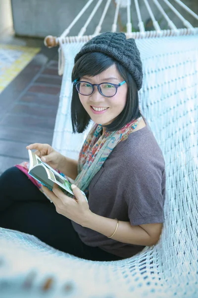 Toothy sorrindo rosto de asiático leitor mulher e bolso livro em ha — Fotografia de Stock