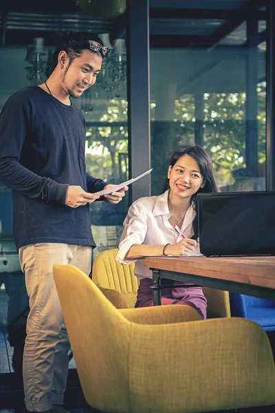 Aziatische jongere freelance man en vrouw die werkt met lachende gezicht — Stockfoto