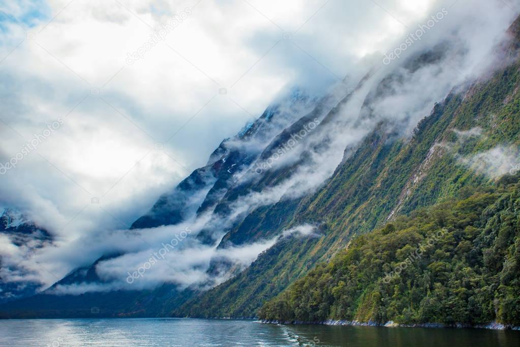 white cloud and high mountain in milford sound fiord land nation