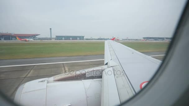 Through window view of passenture plane  taking off on runway — Stock Video