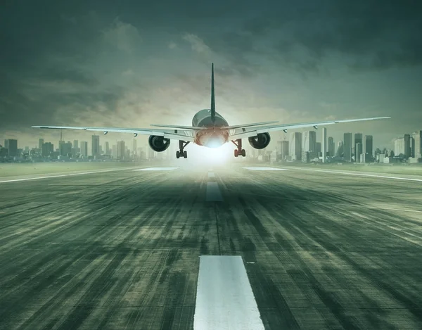 Passenger plane taking off over airport runway and building in c — Stock Photo, Image