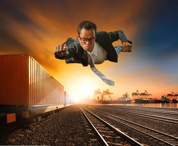 Business man flying against logistic industry background — Stock Photo, Image