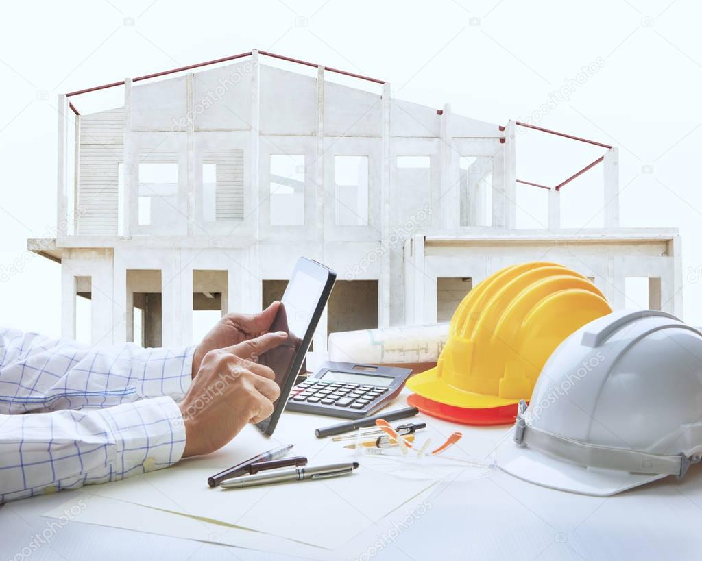 architect working table with house construction background