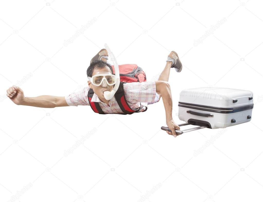 crazy man wearing snorkeling mask flying mid air with traveling 