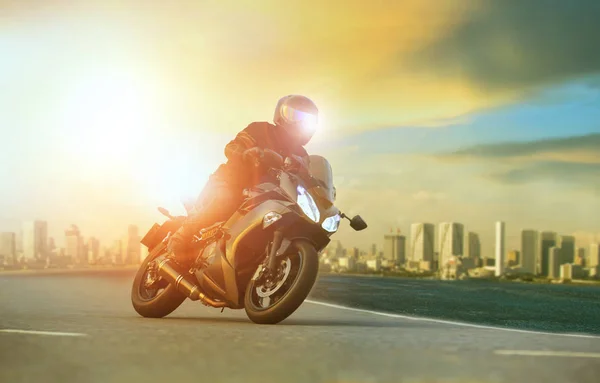 Young man riding big motorcycle leaning on sharp curve with urba — Stock Photo, Image