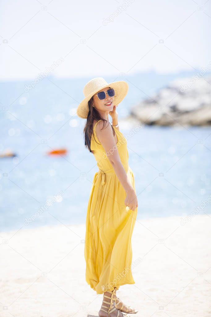 beautiful asian younger woman wearing  yellow dress relaxing on 