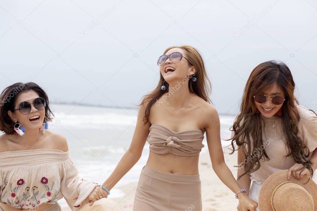 three cheerful asian woman happiness emotion on vacation sea beach