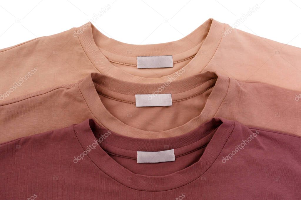 Three unisex basic blank t-shits in pastel colors isolated on white background. Top view. Capsule wardrobe concept. Creative flat lay. Minimal style. Pattern. Trendy clothes collage.