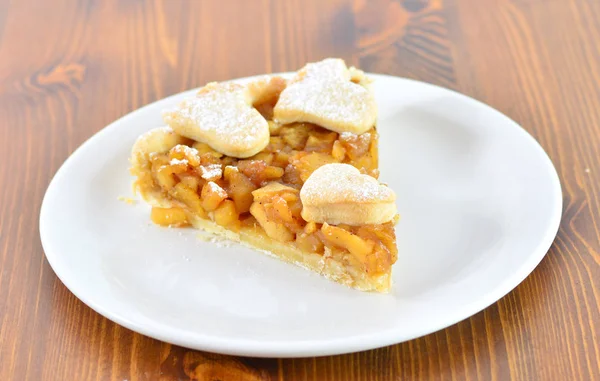 Torta di mele servita con piatto nero sul tavolo di legno — Foto Stock