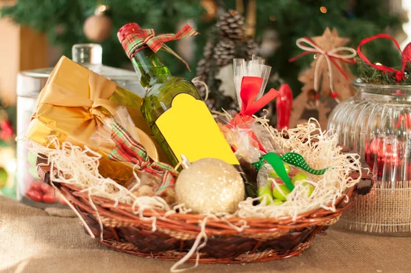 Decorative New Year\'s gift baskets with a set of sweets and alco