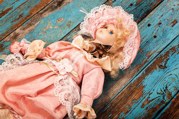 Broken doll on a wooden floor. — Stock Photo, Image