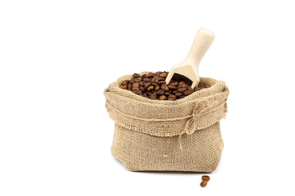 Grains de café dans un sac en toile avec cuillère en bois — Photo