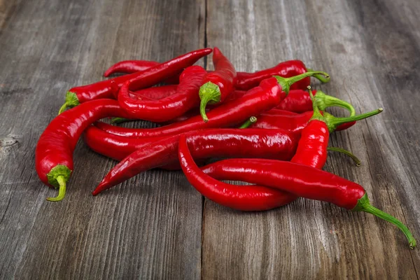 Red hot peppers on wooden background — Stock Photo, Image