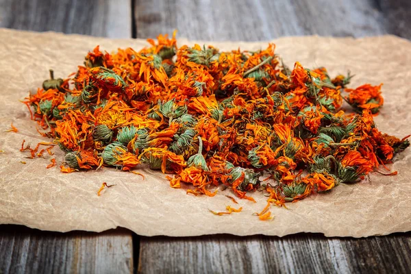 Dried calendula flowers on wooden Medicinal plants — Stock Photo, Image