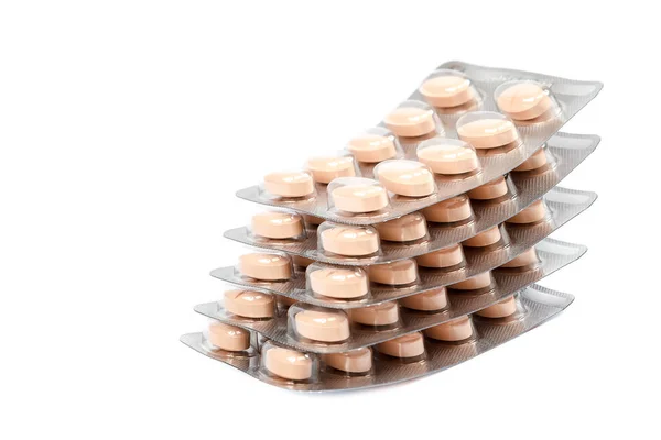 Piller i blisterförpackningar på vit bakgrund. — Stockfoto