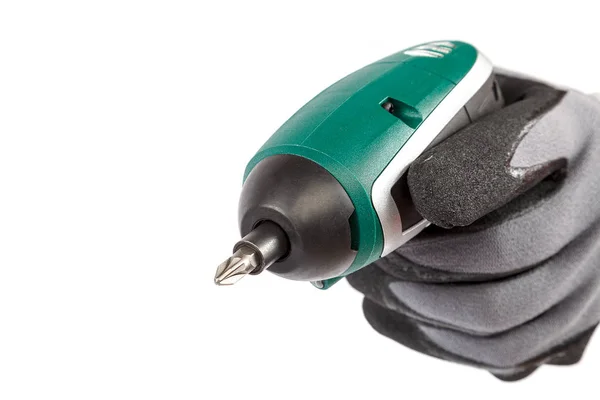 Hand in glove with electric screwdriver on white background. — Stock Photo, Image