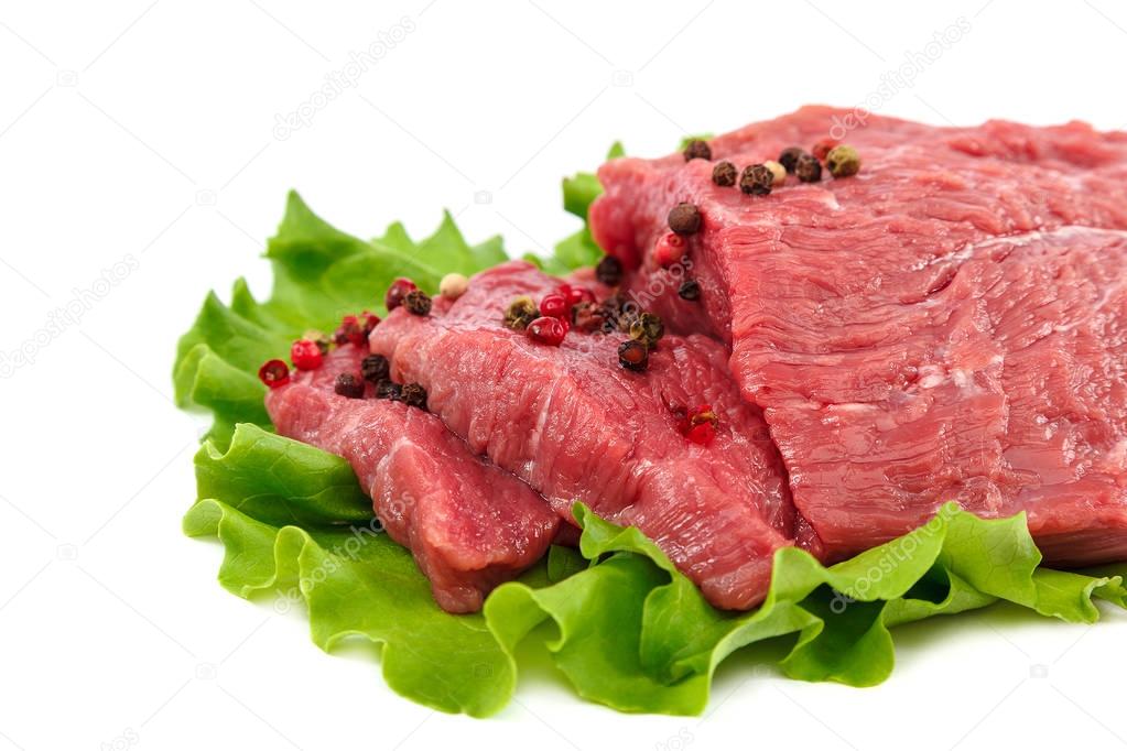 Meat on a cutting board and spices on white background.
