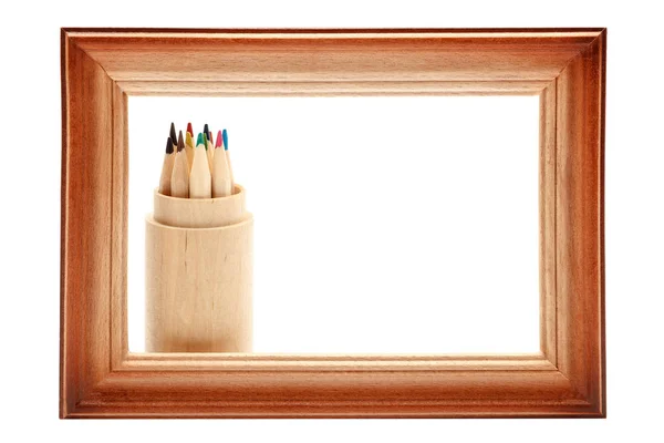 Wooden picture frame and colored pencils on white. — Stock Photo, Image