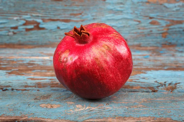 Pomegranate fruit on the a wooden boards — Stock Photo, Image