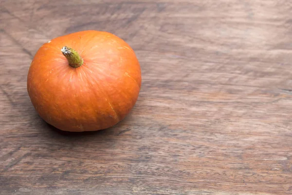 harvest of orange raw pumpkins harvest on table, top view