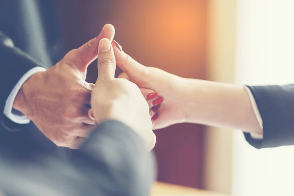 business people join hand while meeting in office