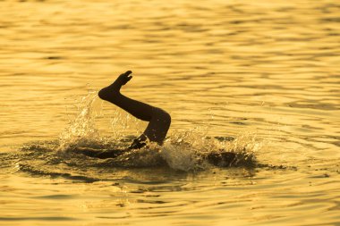 child swimming happily in river