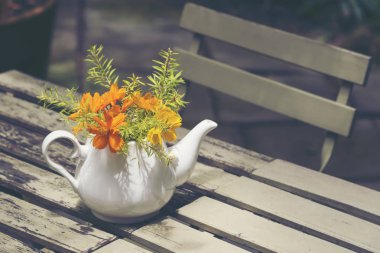 Beautiful flowers in a tableware vase.