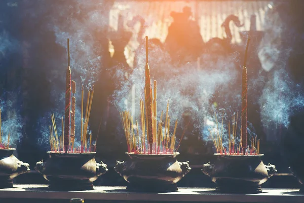 Incense burner sticks on joss stick pot are burning and smoke use for pay respect to the Buddha, Incense smoke use for pray respect to the Buddha in Buddhism life.