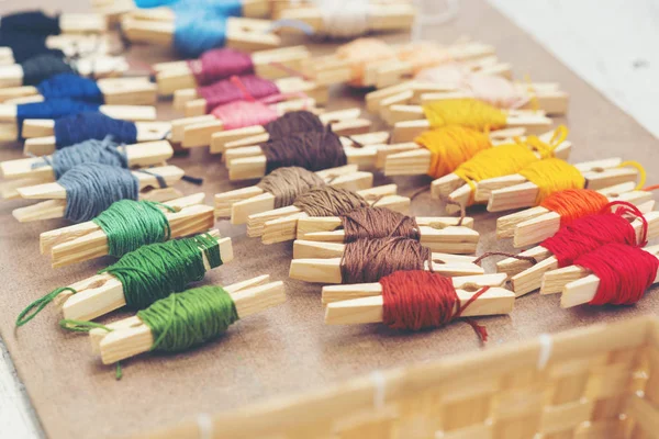 Colorful embroidery threads on table