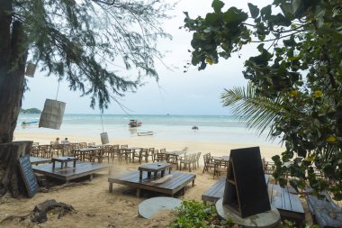 beautiful beach with tables and chairs on the tropical island 