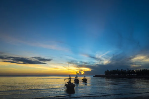 morning sea life with boat and fisherman, in sunrise