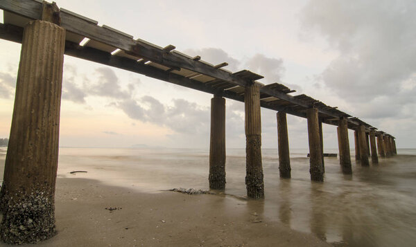 Sunset over the sea. Pier on the foreground